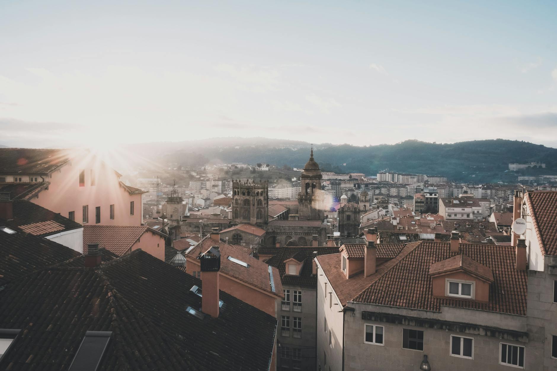 Captivating sunrise over Orense, Spain, highlighting the historic architecture and urban skyline.