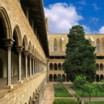 Beautiful Gothic architecture in a historical cloister in Barcelona, Spain showcasing arches and gardens.