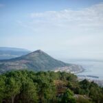 Breathtaking view of the coastline from Serra da Arga, Portugal. Lush greenery and oceanic horizon at daytime.