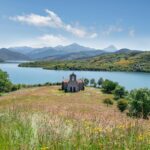 Majestic view of a stone building by a lake in Riaño, Spain.