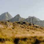 Beautiful view of the Serra de Tramuntana mountains, featuring rocky peaks and grassy slopes.