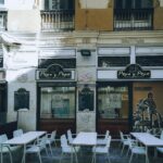 Quaint outdoor dining area at 'Pepa y Pepe' tapas bar in urban setting.