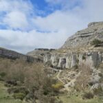 Dramatic view of limestone cliffs and rugged terrain in Aguilar de Campoo, Spain.