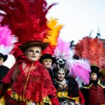 Colorful and festive costumes at Carnaval in Puebla, showcasing vibrant feathers and traditional attire.