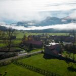 Scenic view of a misty rural landscape in Riaño, Spain with mountains and farms.