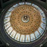 Ornate architectural dome of Valencia Mercado Central featuring intricate design elements.