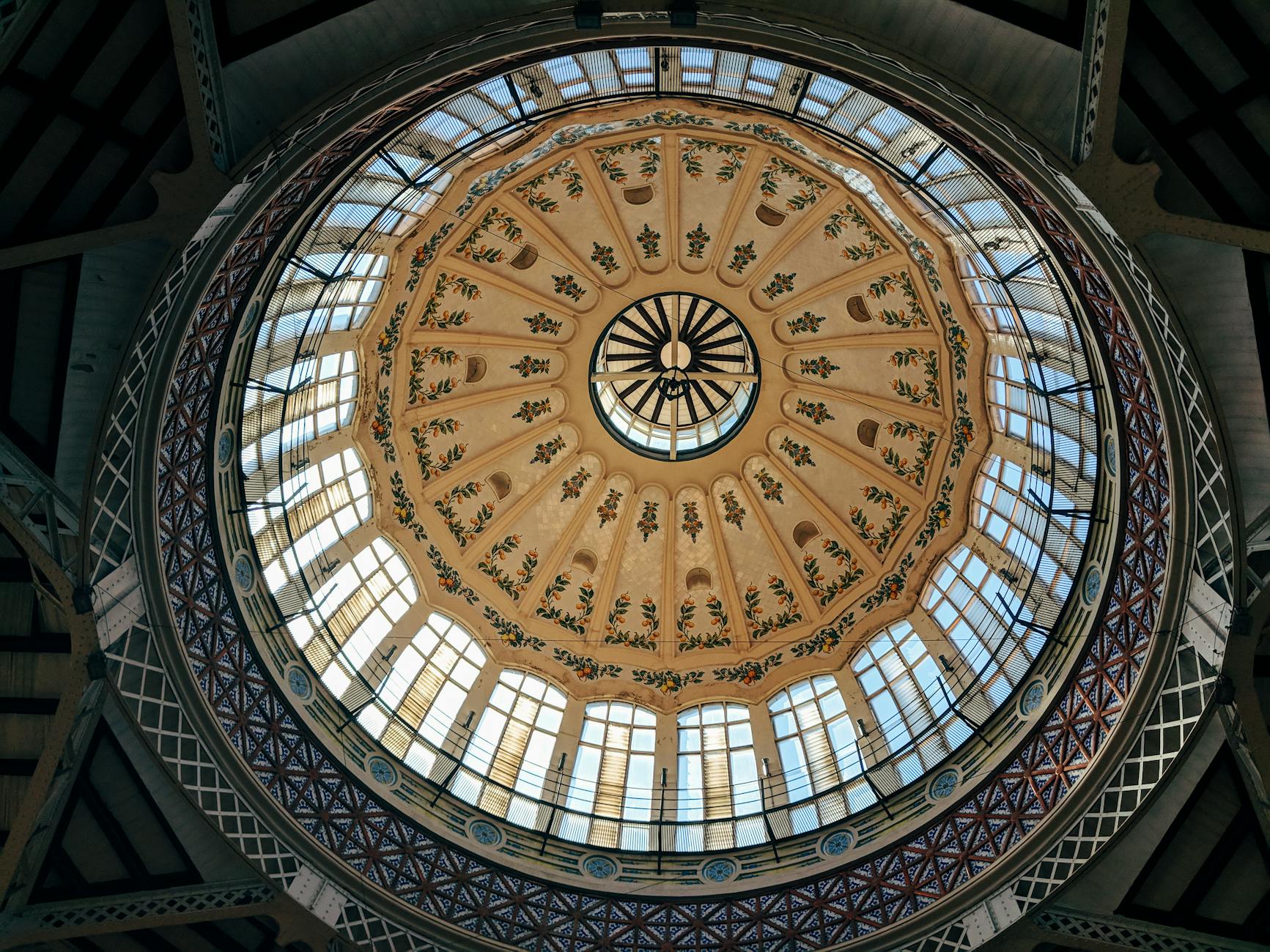 Ornate architectural dome of Valencia Mercado Central featuring intricate design elements.