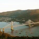 A stunning aerial view of the Rande Bridge spanning Vigo Bay with surrounding hills and water.