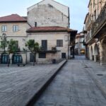 Charming historic European buildings lining a peaceful stone-paved street, capturing a timeless architectural essence.
