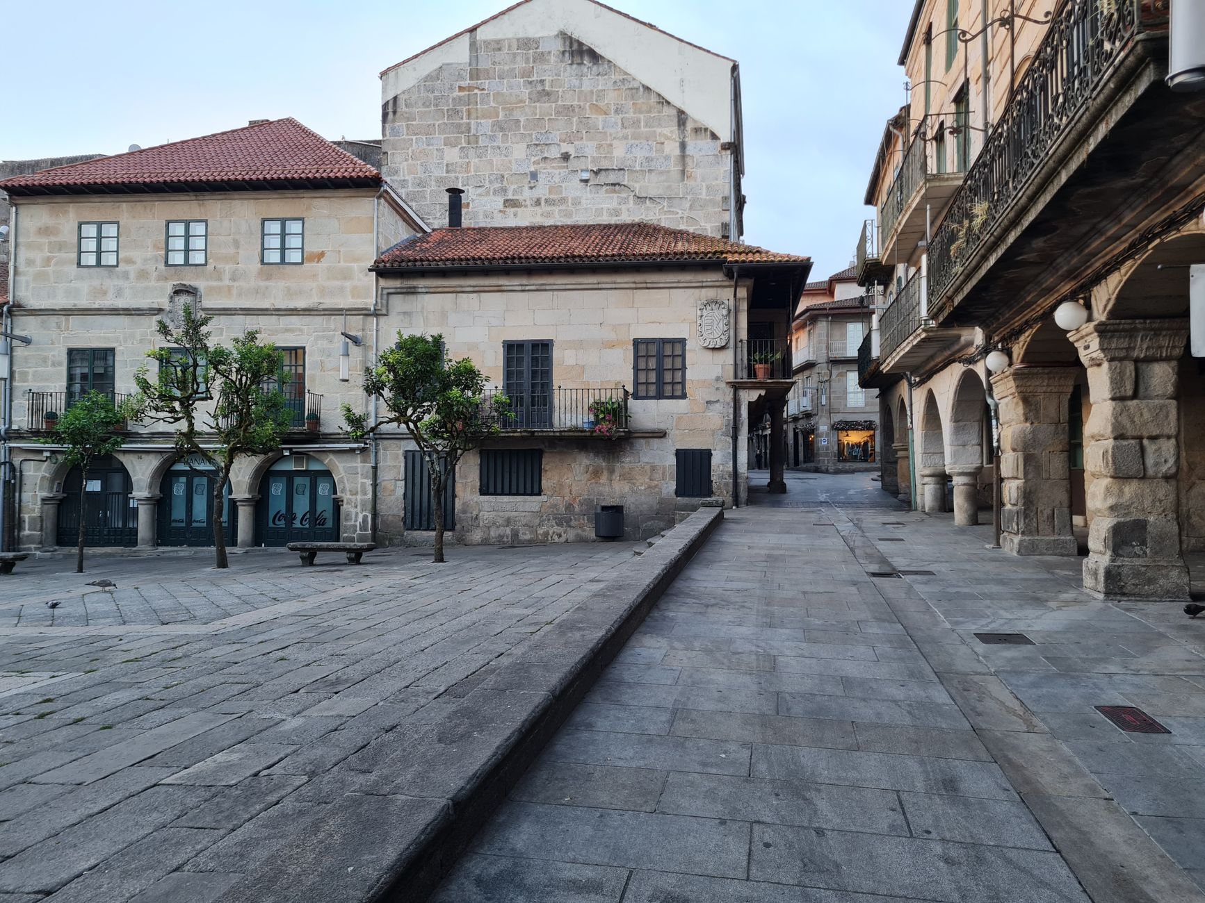 Charming historic European buildings lining a peaceful stone-paved street, capturing a timeless architectural essence.