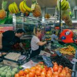 Busy marketplace in Valencia with diverse fruits and vegetables.