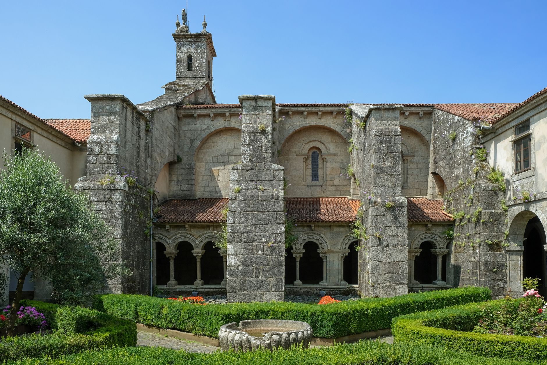Beautiful medieval courtyard with arches and garden in Santiago de Compostela.