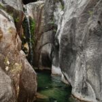 Serene waterfall in rocky landscape at Cascata do Arado, Vilar da Veiga, Portugal.