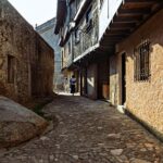 Sunlit cobblestone alley in historic La Alberca, Castilla y León, Spain.