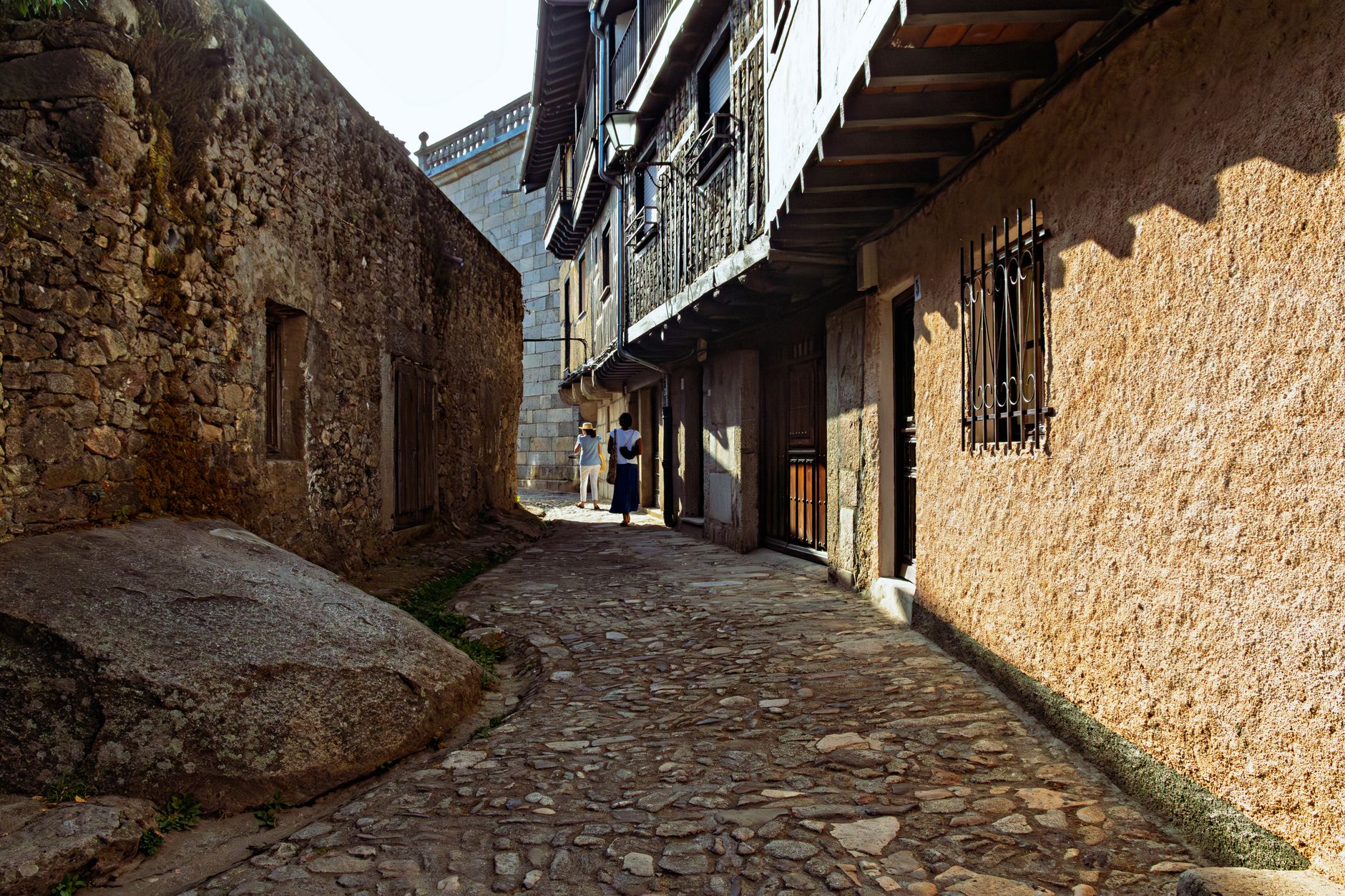 Sunlit cobblestone alley in historic La Alberca, Castilla y León, Spain.
