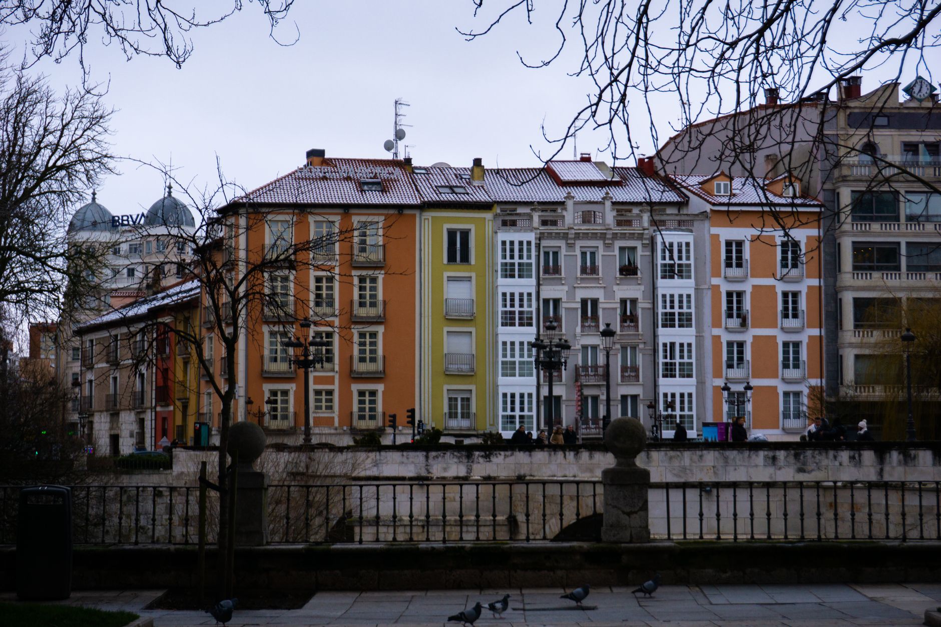 Charming colorful buildings along a river in Burgos, Spain.