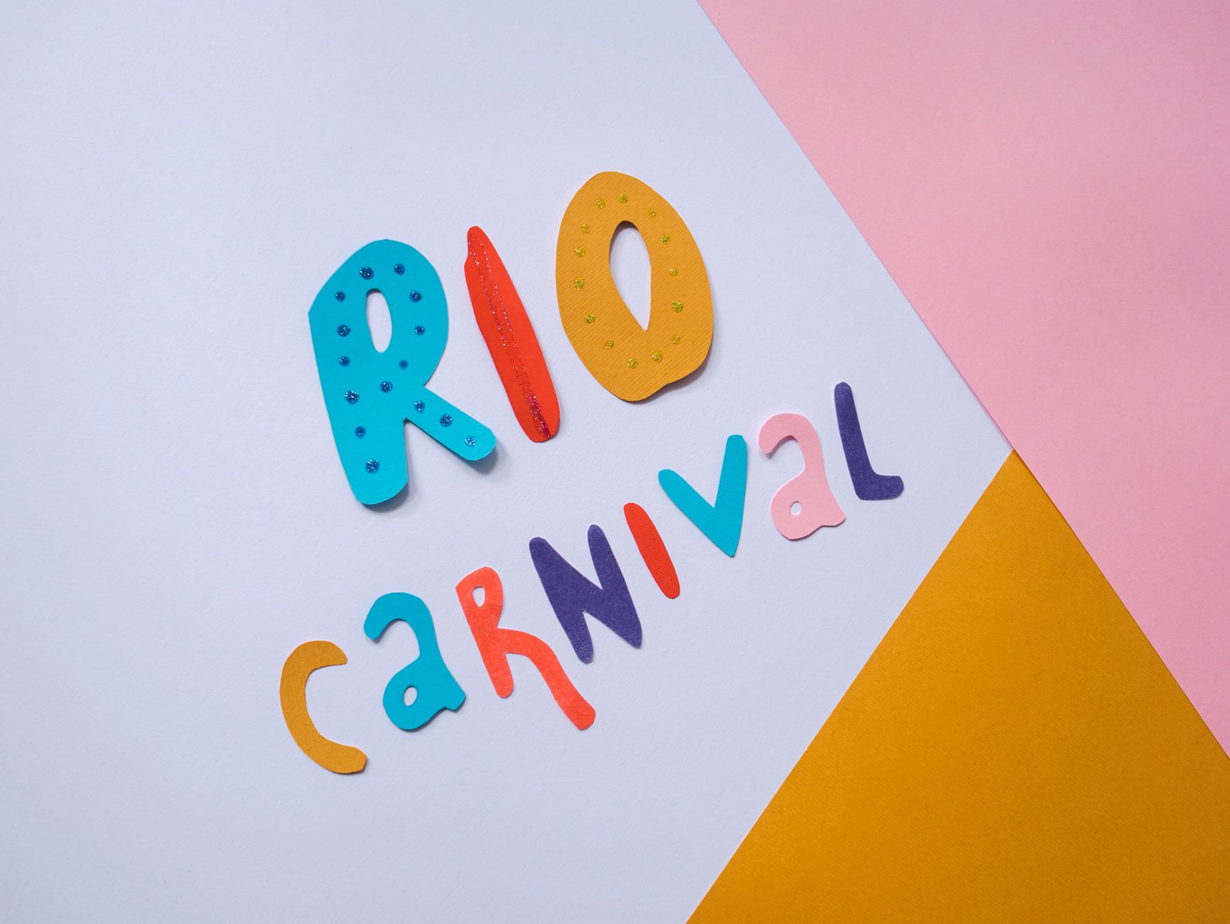 Creative and vibrant cut-out letters spelling 'Rio Carnival' on a colorful background.