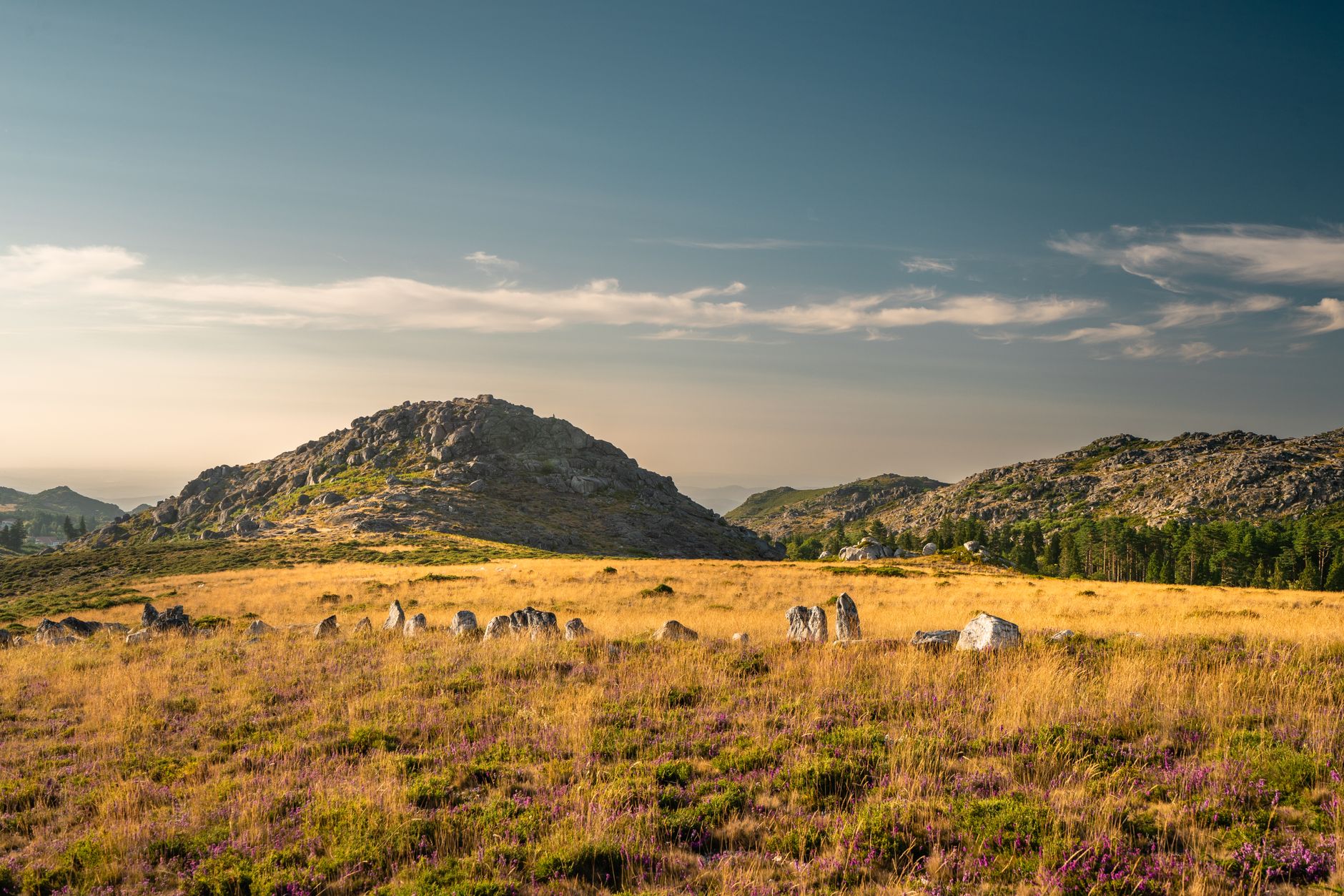 Beautiful sunset view of rocky hills and grassy fields in Albergaria da Serra, Aveiro, Portugal.