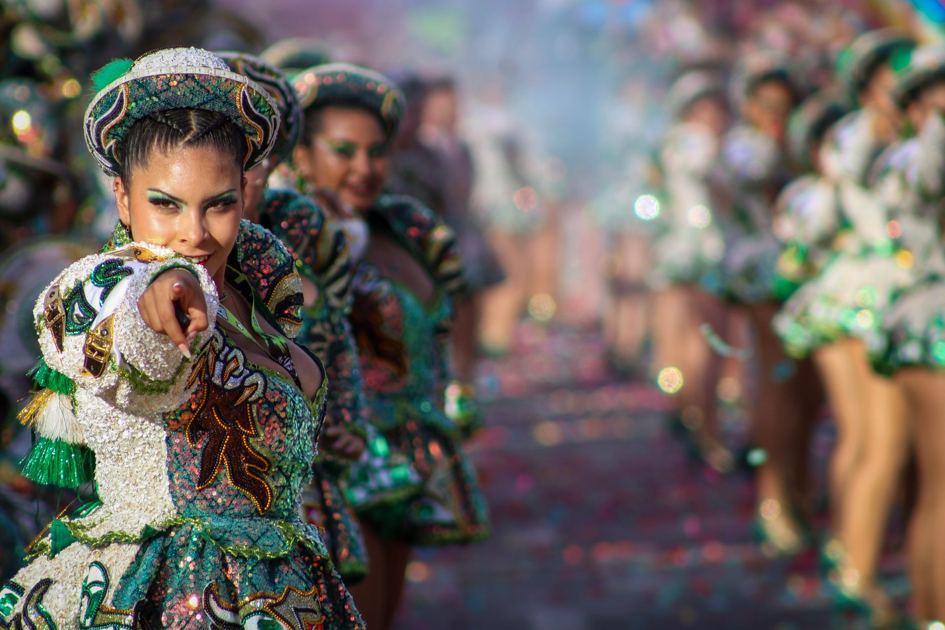 Vibrant dancer in traditional attire at Arica y Parinacota Carnaval parade.