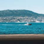 A picturesque view of Vigo, Spain, featuring a boat on the ocean.
