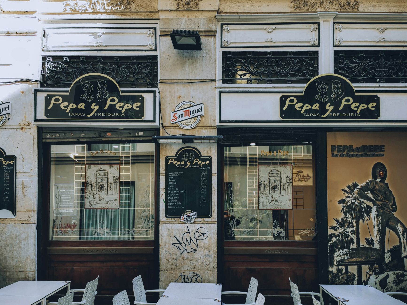 Front view of 'Pepa y Pepe' tapas bar showcasing signage and outdoor seating.