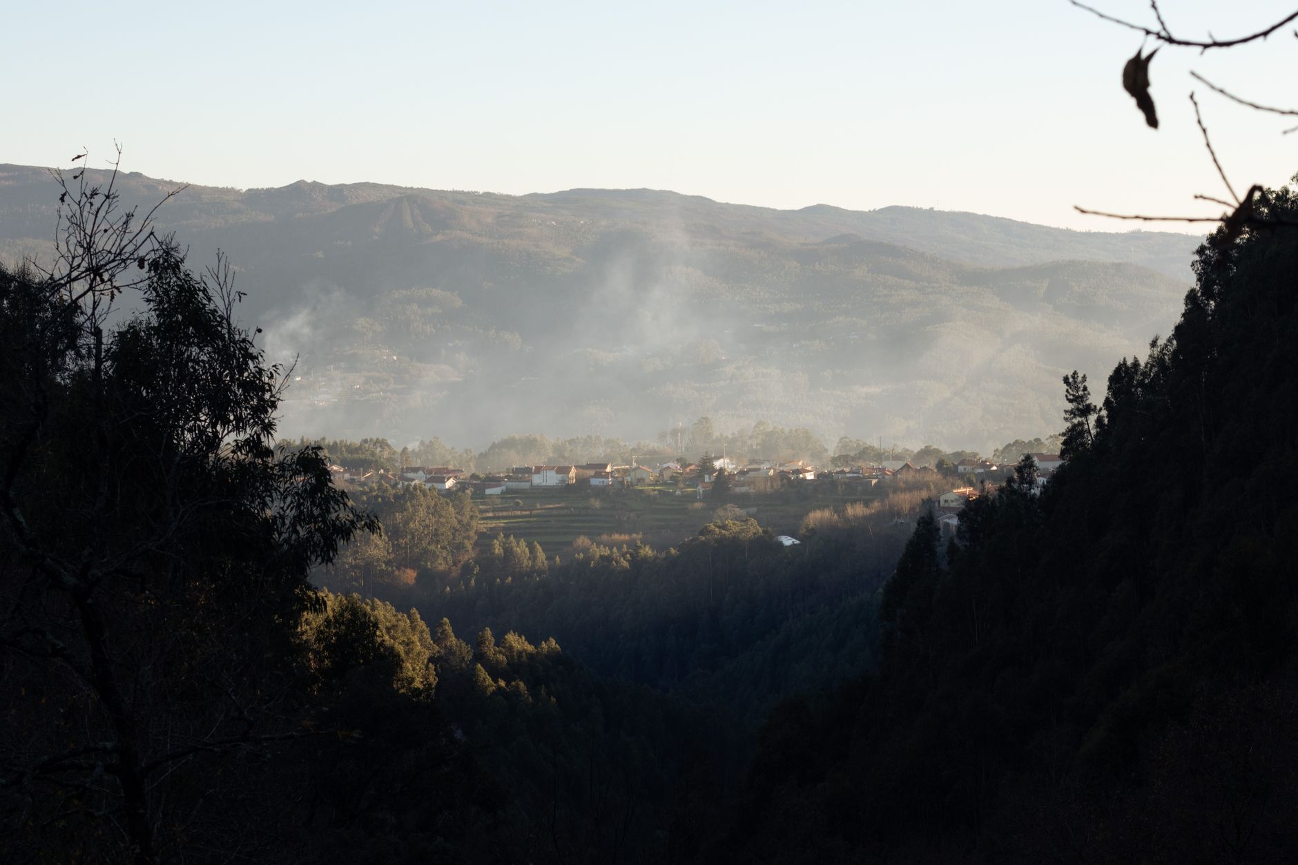 Serene landscape view of Sever do Vouga valley in Portugal during day with smoky horizon.
