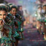 Vibrant dancer in traditional attire at Arica y Parinacota Carnaval parade.