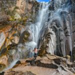 Person joyfully experiencing the majesty of Cusárare Waterfall, Guachochi, Mexico.