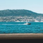 A picturesque view of Vigo, Spain, featuring a boat on the ocean.