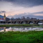 Scenic view of Ponte de Lima's historic bridge and church at twilight.