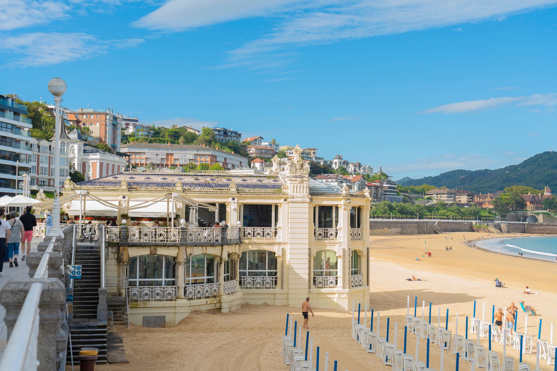 A sunny day view of the beautiful beachfront building in San Sebastián, showcasing its architectural elegance and vibrant surroundings.