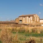 A classic rural building set in a wheat field in rural Castilla y León, Spain.
