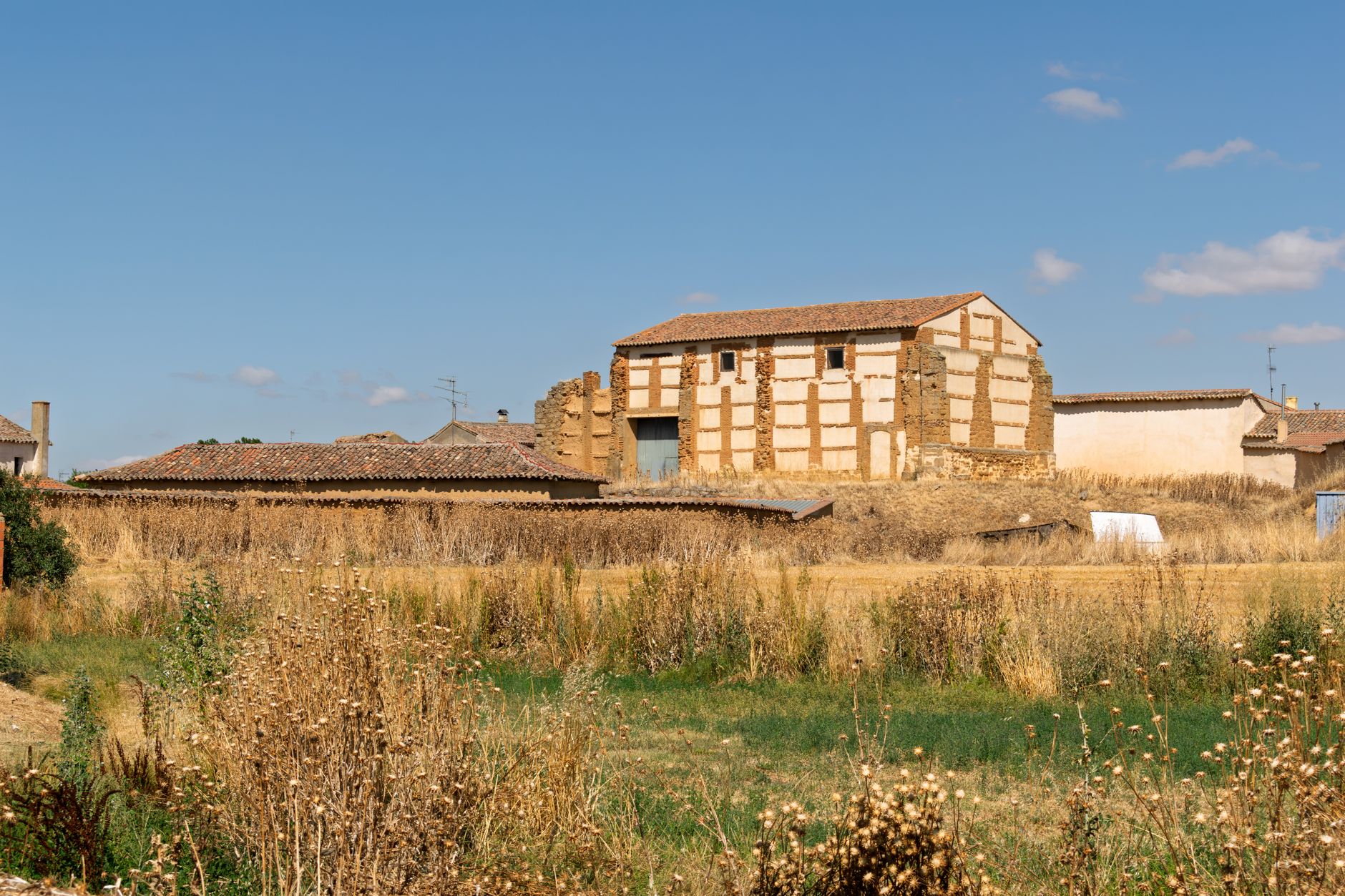 A classic rural building set in a wheat field in rural Castilla y León, Spain.