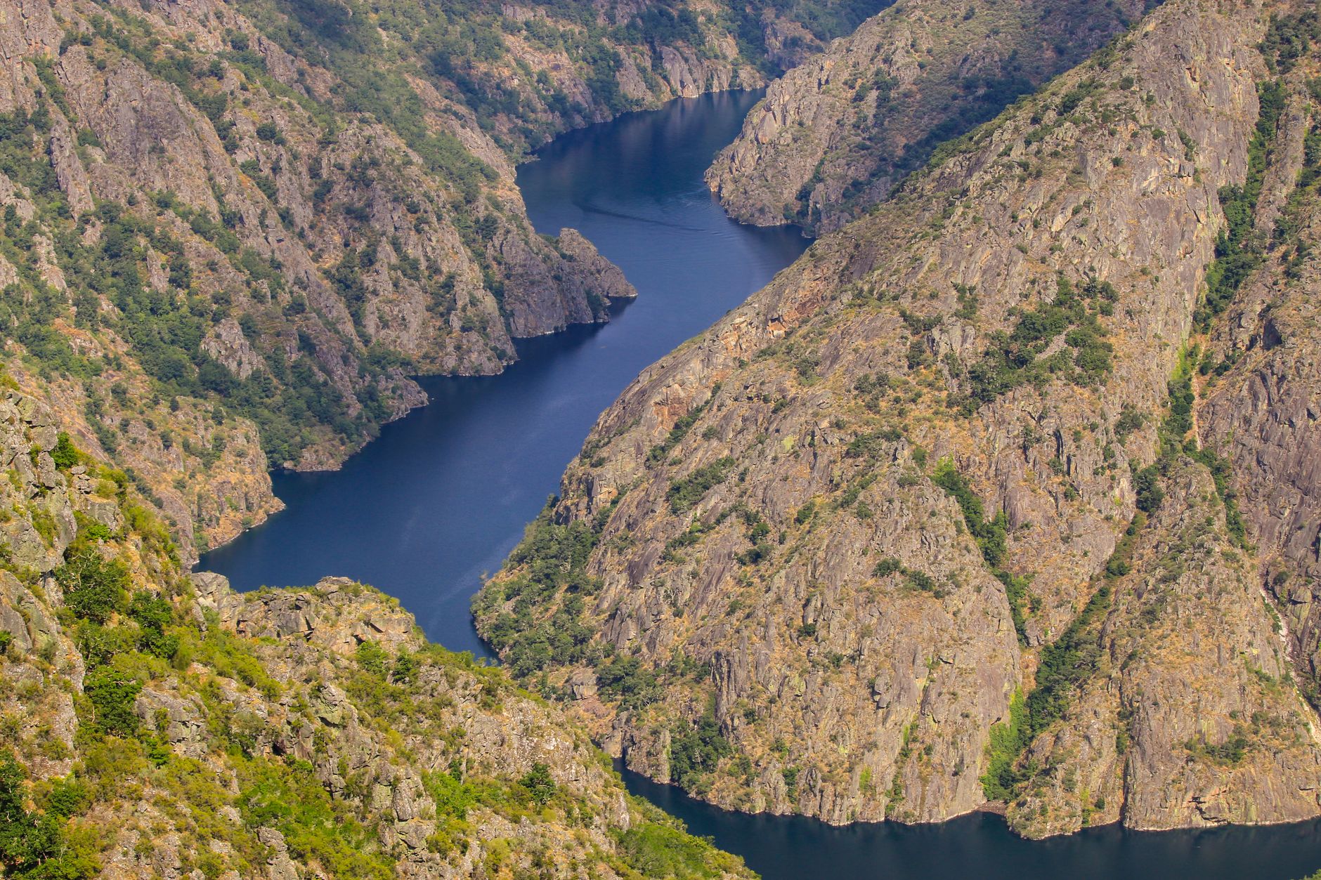 Majestic view of Ribeira Sacra gorge and river in Galicia, Spain, showcasing rugged cliffs and serene waters.
