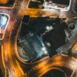 Explore the captivating aerial night view of intricately lit city streets and buildings.