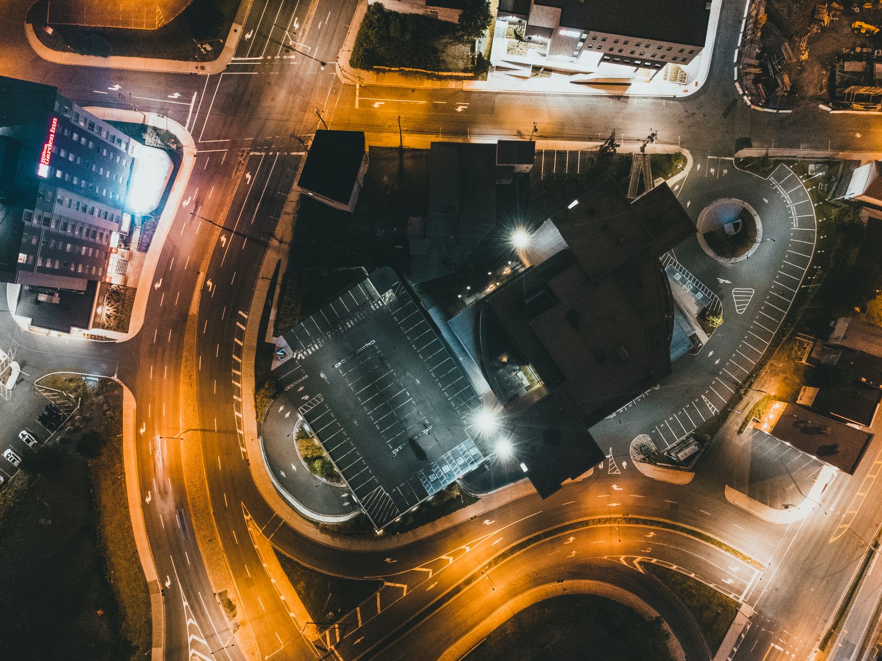 Explore the captivating aerial night view of intricately lit city streets and buildings.