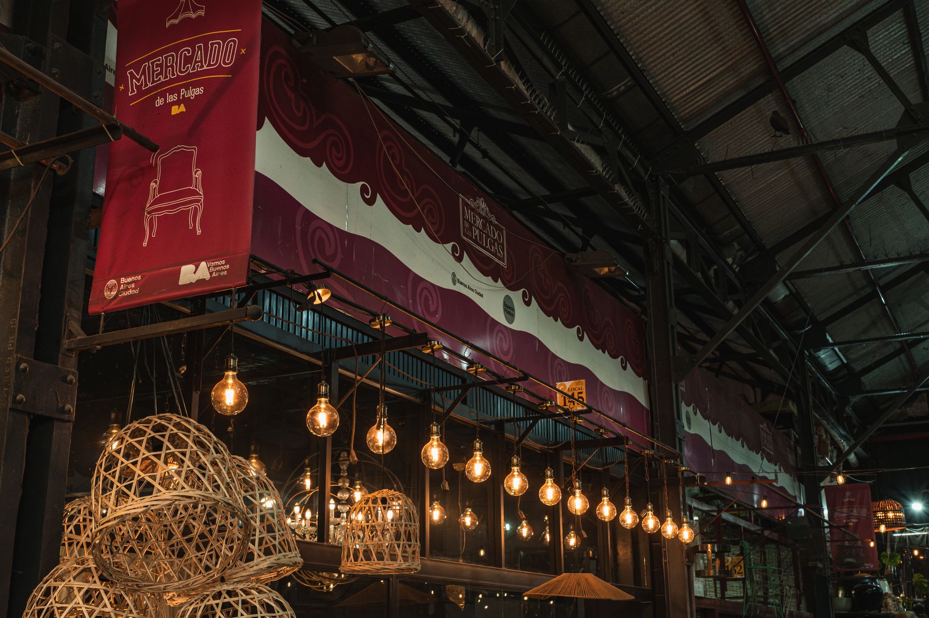 Warm lighting and rustic decor inside the Mercado de las Pulgas flea market in Buenos Aires, Argentina.