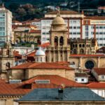 Panoramic view of historical architecture in Ourense, showcasing church towers against modern buildings.